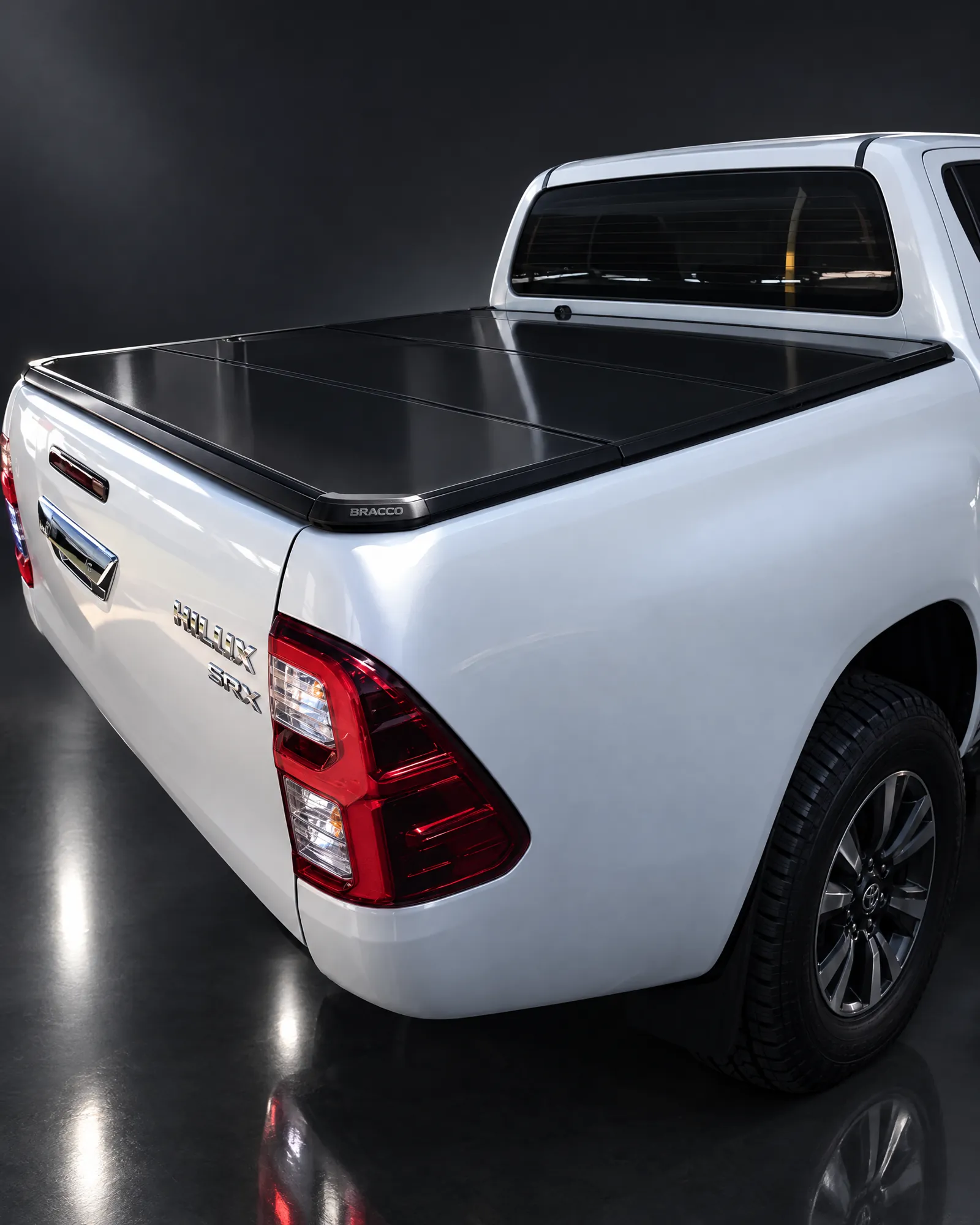 Toyota Hilux con tapa rígida plegable Bracco en estudio oscuro (referencia de la línea)